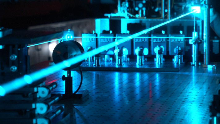 Photons in a laser beam.