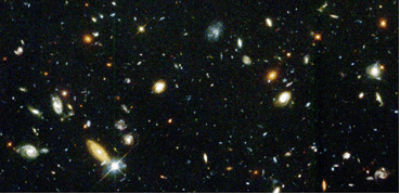 The deep field image of galaxies is accompanied by an animation showing the position in the sky and the extent of the telescope's magnification. 